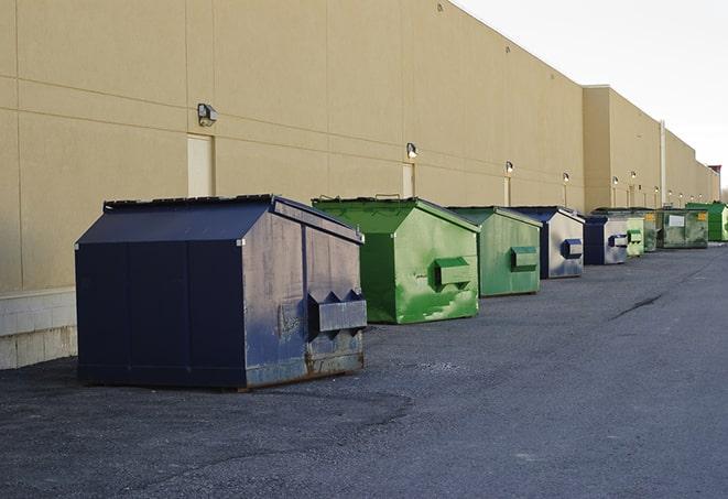 a group of dumpsters lined up along the street ready for use in a large-scale construction project in Belleair Bluffs FL